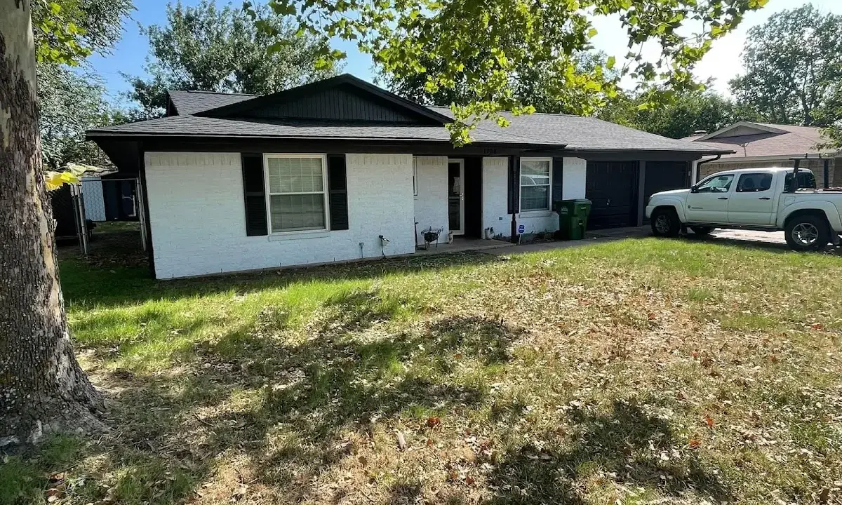 Professional roofing crew working on a residential roof in Garden City